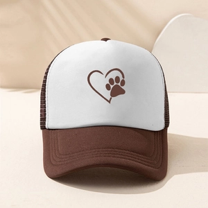 Detail of a brown and white trucker hat featuring a dog paw heart print and mesh back