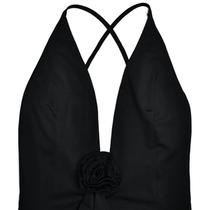 Detail of sexy deep V-neck black dress with 3D floral accent and crisscross back straps