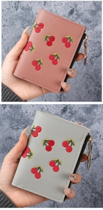 Close-up of cherry embroidery on litchi pattern short wallets with zipper detail