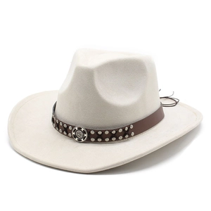 Detail of western fedora hat with studded leather band and vintage metal ornament