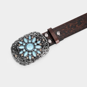 Close-up of vintage leather belt with floral silver buckle and turquoise stones