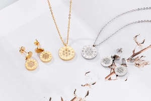 Detail of gold and silver jewelry sets with Roman numerals and crystals on white background