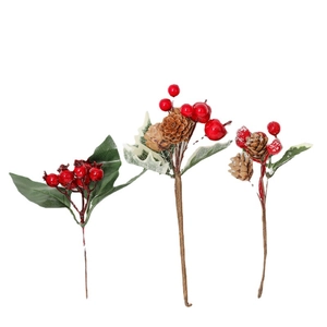 Christmas berry pine cone picks with red berries and green leaves on white background