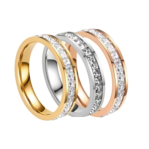 Three-piece stainless steel eternity ring set in gold, silver, and rose gold with channel-set stones