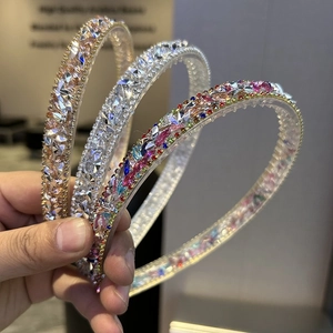 Close-up of sparkling crystal rhinestones on baroque hairbands in gold and silver