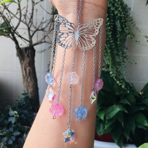 Detailed close-up of a silver butterfly suncatcher with colorful acrylic flower beads