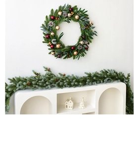 Christmas wreath and garland set with red ornaments and pine cones for holiday decor
