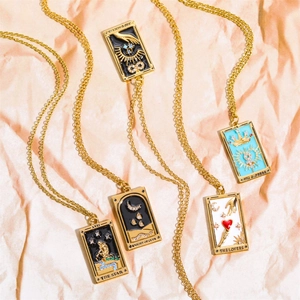 Detailed shot of tarot card necklaces with colorful enamel and sparkling rhinestones
