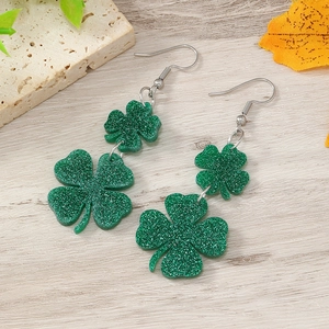 Close-up of Saint Patrick's Day green glitter resin shamrock clover drop earrings set