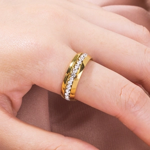 Classic gold eternity ring with round clear crystals on elegant silk background
