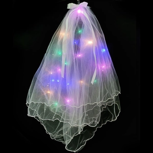 Macro shot of white mesh veil with colorful LED lights and a bow on a dark background
