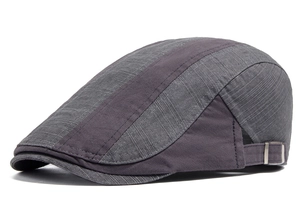 Detail view of cotton beret featuring side silver metal adjustment buckle and stitching