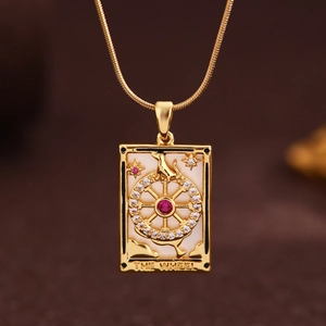 Macro view of Wheel of Fortune tarot pendant with red crystal and sparkling pavé stones