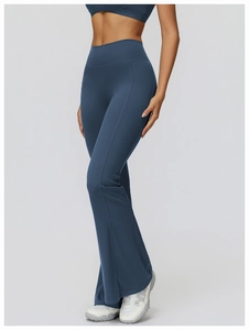 Close-up of high-waist flared yoga pants in dusty blue featuring slimming seam details