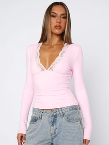 Close-up of pink long-sleeve top featuring deep V-neck and delicate white lace trim detail