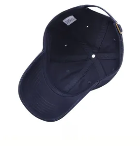 Detailed interior of navy blue cotton baseball cap showing seams and white washing label