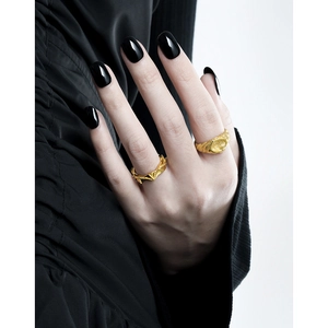 Minimalist S925 sterling silver golden rings with irregular texture worn by a fashion model