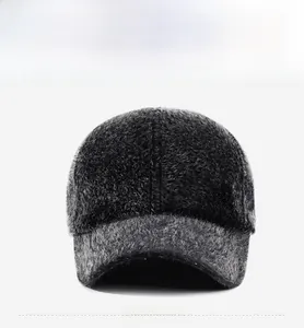 Close-up of deep gray faux fur baseball cap featuring a golden rectangular metal logo