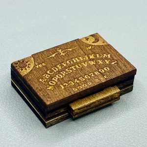 Handcrafted miniature wooden spirit board box with detailed mystical engravings for decor