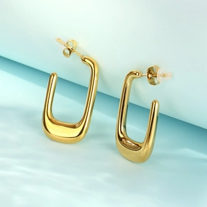 Detailed view of gold French U-shaped hollow stainless steel earrings with polished finish