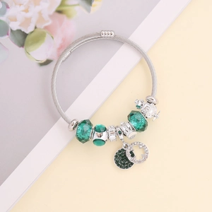 Sparkling silver and emerald green charm bracelet with crystal beads and crown pendant
