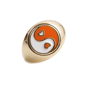 Detail of gold-tone ring featuring heart-shaped yin yang pattern with enamel finish