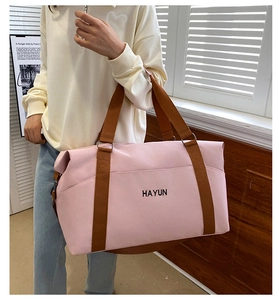 Model showing large capacity pink travel bag with shoulder strap and Hayun logo