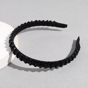 Detailed view of handmade black beaded headband with sparkling crystal embellishments