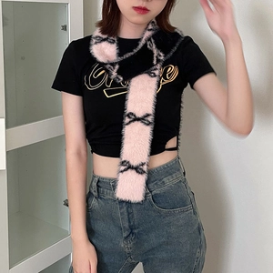 Detail view of a pink and black plush scarf with cute bow patterns on a model