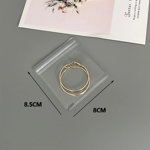 Thickened transparent PVC jewelry bag showing 8.5x8cm dimensions for earrings
