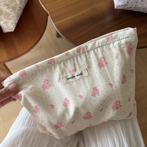 Detailed close-up of floral print cotton makeup bag with a Simple Wish woven label