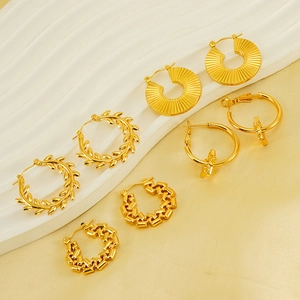 Detailed close-up of five unique 18K gold-plated hollow hoop earrings on a wavy stand
