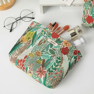 Detail of floral embroidery on a large makeup bag with vintage patterns and texture