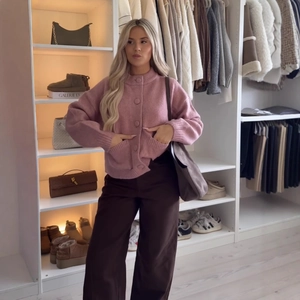 Pink oversized chunky knit cardigan with ribbed crew neck and large buttons for women