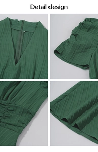 Detailed close-up of V-neckline, puff sleeves, and textured green fabric on summer dress