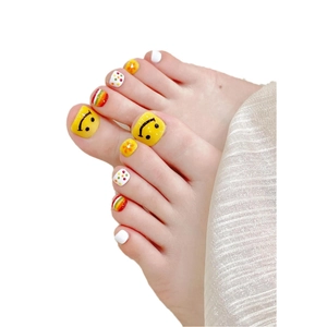 Handmade summer toe press-on nails set with yellow smiley faces and colorful patterns