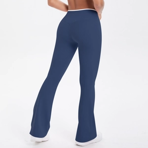 Close-up of high-waist yoga pants featuring white contrast piping and flared leg design