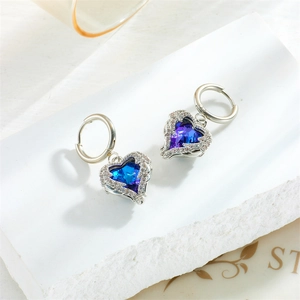 Elegant silver earrings with heart-shaped blue gradient crystals and diamond accents