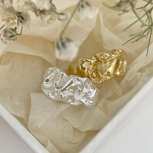 Detail shot of 925 silver rings with modern crumpled foil texture in gold and silver