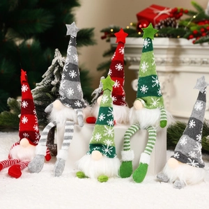 Detail of six festive Christmas gnomes with knitted hats and plush beards on snow