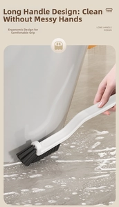 Detail of ergonomic long handle crevice brush with stiff bristles cleaning bathroom tiles