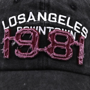 Detail of 3D 1981 patch embroidery on vintage washed black cotton baseball cap
