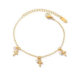 Elegant gold stainless steel bracelet featuring pearl charms and cross pendants