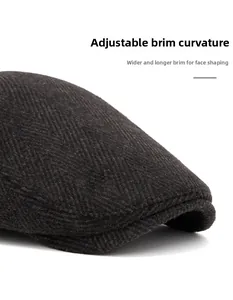 Close-up of herringbone newsboy cap featuring wide foldable brim for face contouring