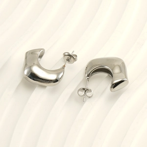 Polished silver stainless steel C-shaped geometric hoop earrings on a white surface