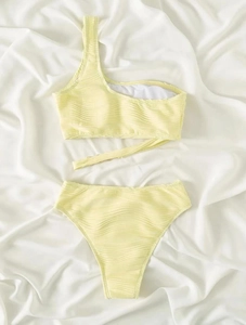 Detailed view of light yellow ripple textured one-shoulder bikini top with strap ties