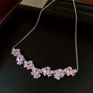 Detailed view of flower pendant necklace with pink zircon gemstones and silver chain