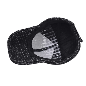 Detail view of the tweed baseball cap interior with fabric lining and structural seams