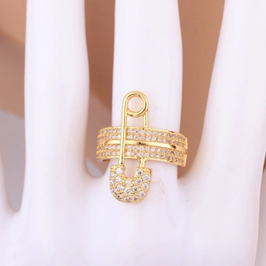 Close-up of safety pin design ring with white zircon stones on white mannequin hand