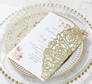 Detailed laser cut floral wedding invitations with glitter gold and ivory pocket envelopes
